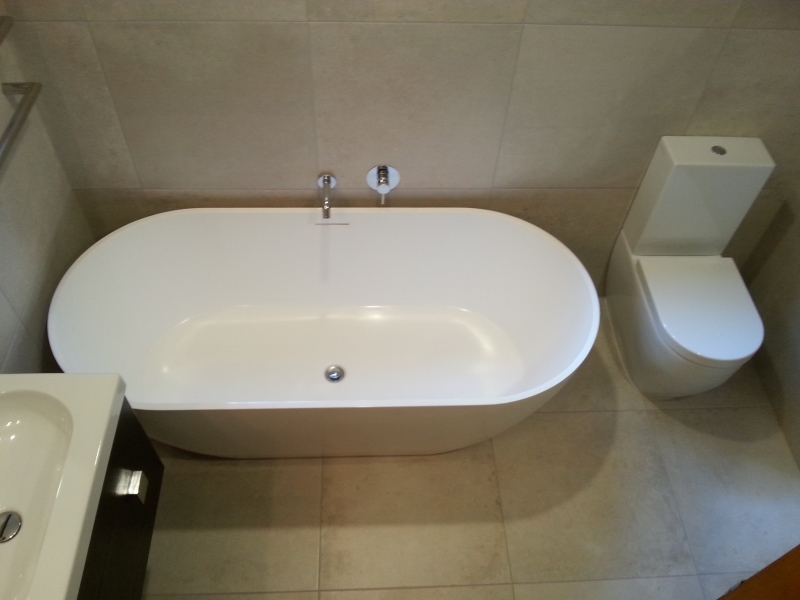 Freestanding Ceramic Bath, Toilet Sitting on top of 600x600 Tiles