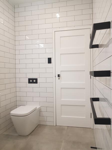 Toilet & black heated towel rails